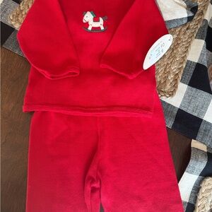 Christmas outfit size 3-9 mos. Runs large. Red with rocking horse detail.